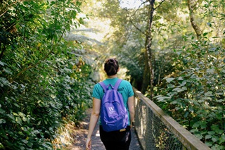Person walking in the gardens with a backpack on.