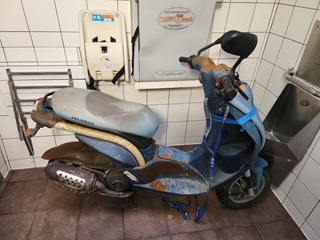 Scooter in a public toilet.