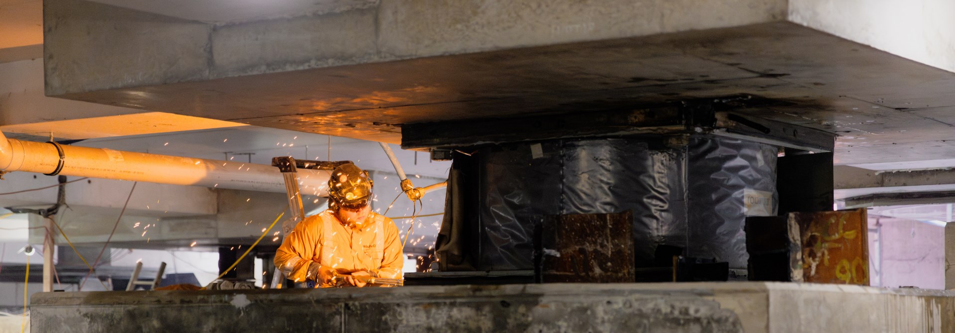 Person working on a base isolator.