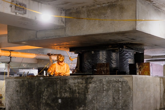 Person working on a base isolator.