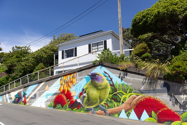 Colourful mural on the side of a concrete wall.