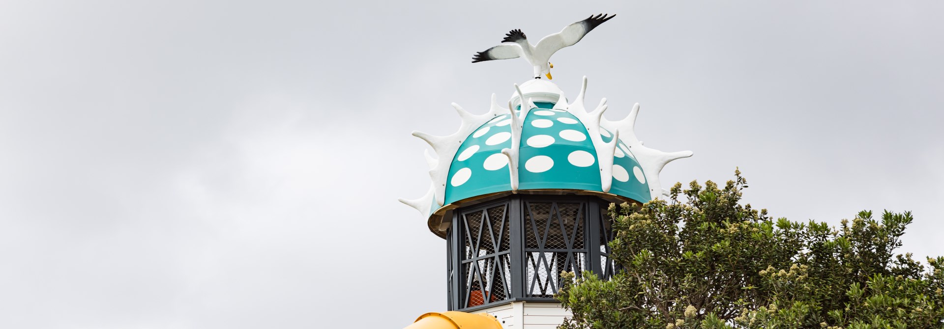 Refurbished cupola dome with seagull on top placed on iconic slide in Frank Kitts Playground site.