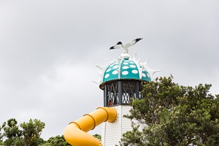Refurbished cupola dome with seagull on top placed on iconic slide in Frank Kitts Playground site.