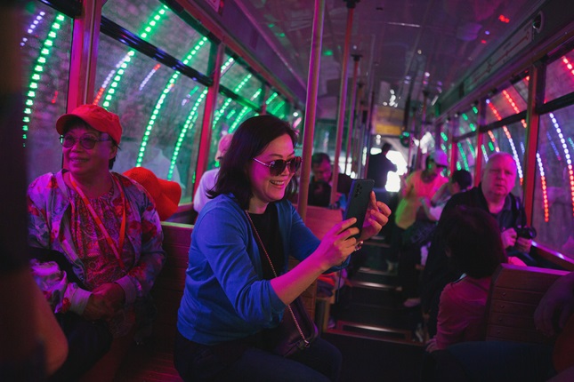 Person sitting down inside the cable car with lights surrounding them from the tunnel.