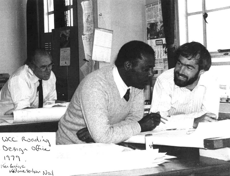 Two men sitting at a desk.