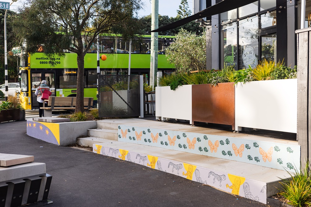 Painted murals on steps outside a bar.