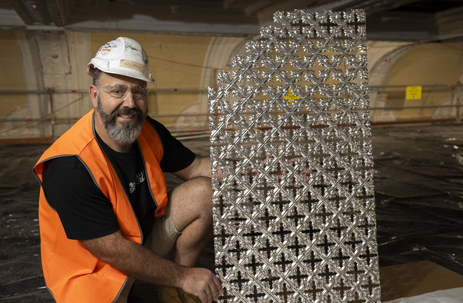 a contractor posing next to a pressed metal sheet