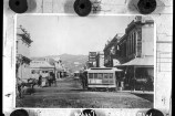 Image of Horse Trams in Cuba Street, corner of Dixon Street. Te Aro House in the background is advertising a Salvage Sale.