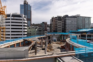 Demolition of CAB building with scaffolding to the sides and buildings in the background.