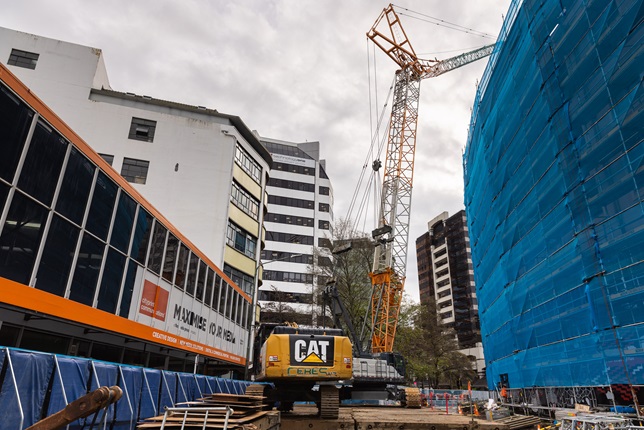 The crane situated on Wakefield Street with scaffolding to the side.