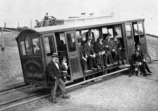 Image of then prime minister Richard Seddon and a group of people on the cable car on opening day 1902