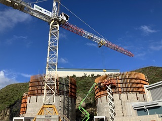Crane towering above two buildings which are part of the Moa Point sludge minimisation facility.