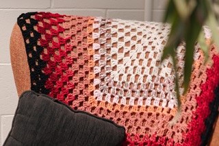 Crocheted blanket on an armchair.