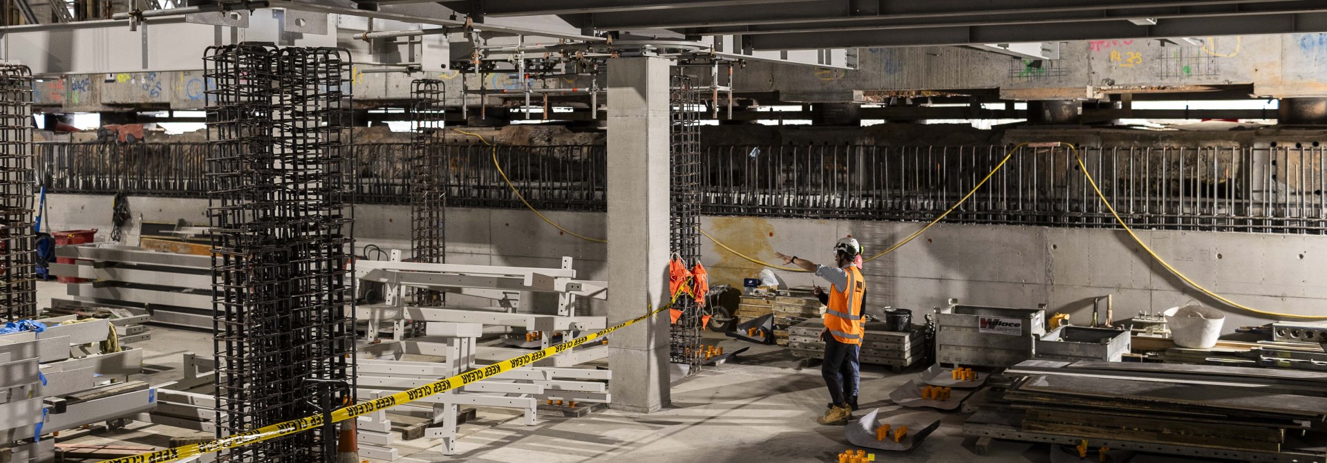 The basement of Te Whare Whakarauiki with two people standing in the construction wearing high vis vests.
