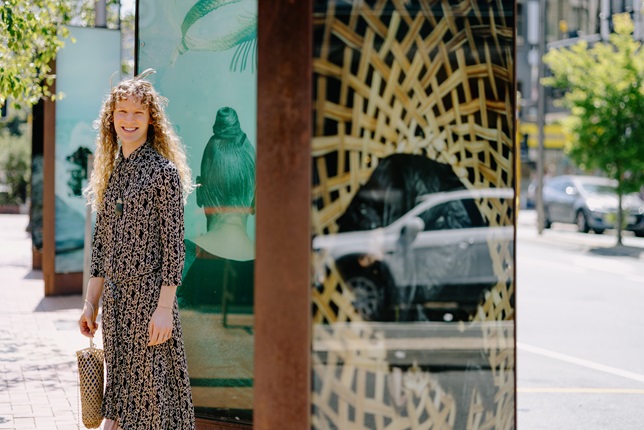 A person standing infront of lightboxes.