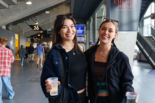 Two women smiling and holding FillGood cups.
