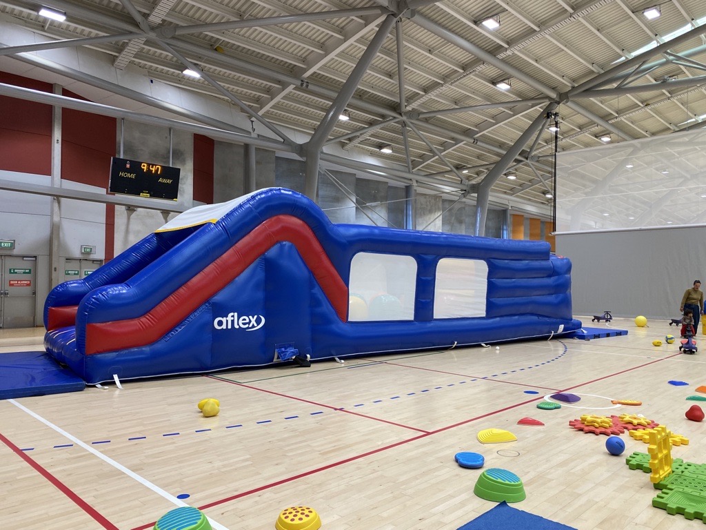 Large blue inflatables set up at a sports centre.