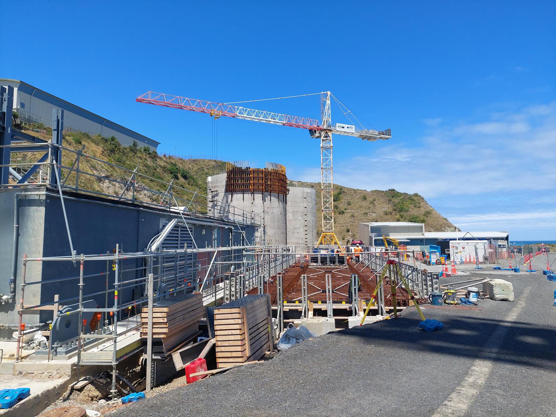 A crane in the background with construction occurring around it.