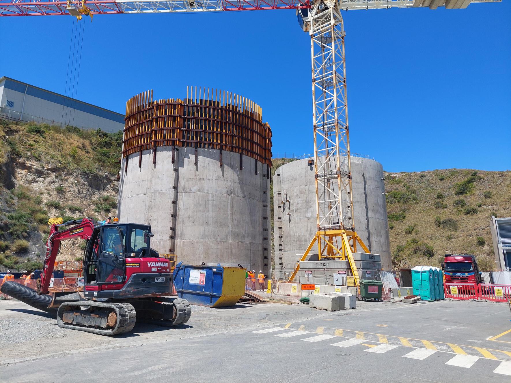 Two digestors at Moa Point Sludge Minimisation Facility surrounded by construction.