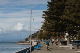 People running and walking down Oriental Parade.