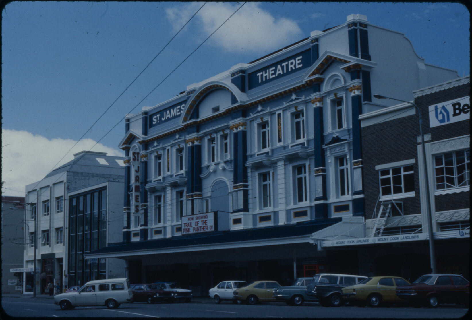 Archival image of St James Theatre with a row of vintage cars parked infront of it. Wellington City Council Archives, 00557-948-20.