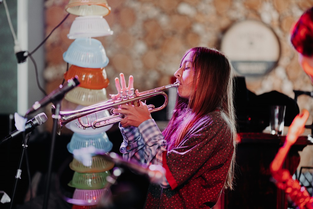 Person playing  trumpet on a stage.