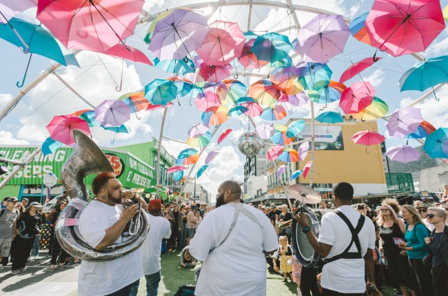 Umbrellas hanging over the top of a group of performers.
