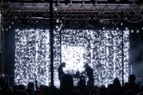 A light display showing on a large screen on a stage.