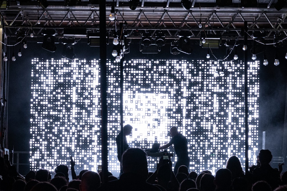A light display showing on a large screen on a stage.