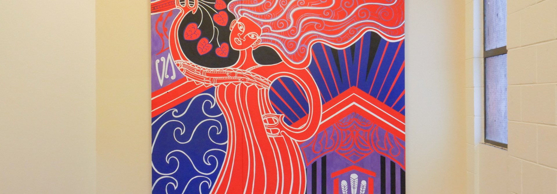 Brightly coloured mural hanging on a wall.
