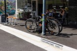 Bikes parked on the footpath.