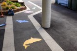 A close up of stencils on the pavement.