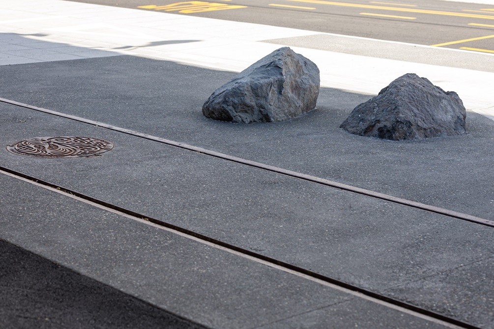 Urban streetscape with a close up of tram lines in the ground.