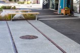Urban streetscape with a close up of tram lines in the ground.
