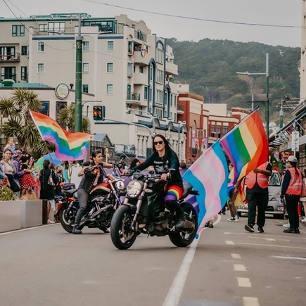 Motorbikes with rainbow flags in Pride Parade on Dixon Street.