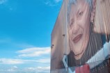 June Jackson mural on the side of a building on the waterfront.
