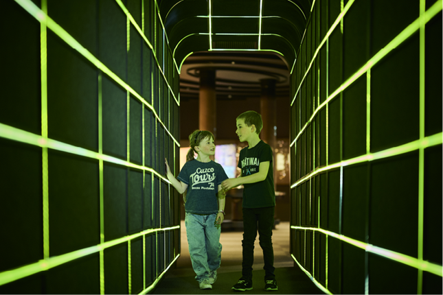 Young people walking through sci fi tunnel at Space Place.