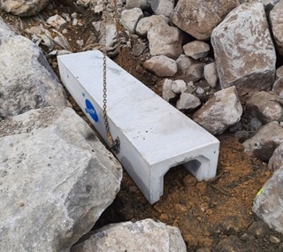 Penguin habitat being installed inbetween large and small rocks.