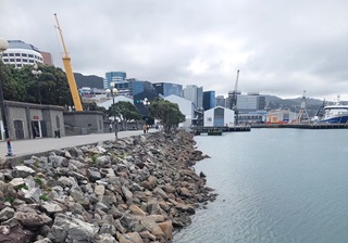 A view of the Wellington waterfront and the promenade that leads to a large arena in the background.