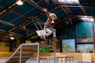 A young kid jumping in a recreation centre.