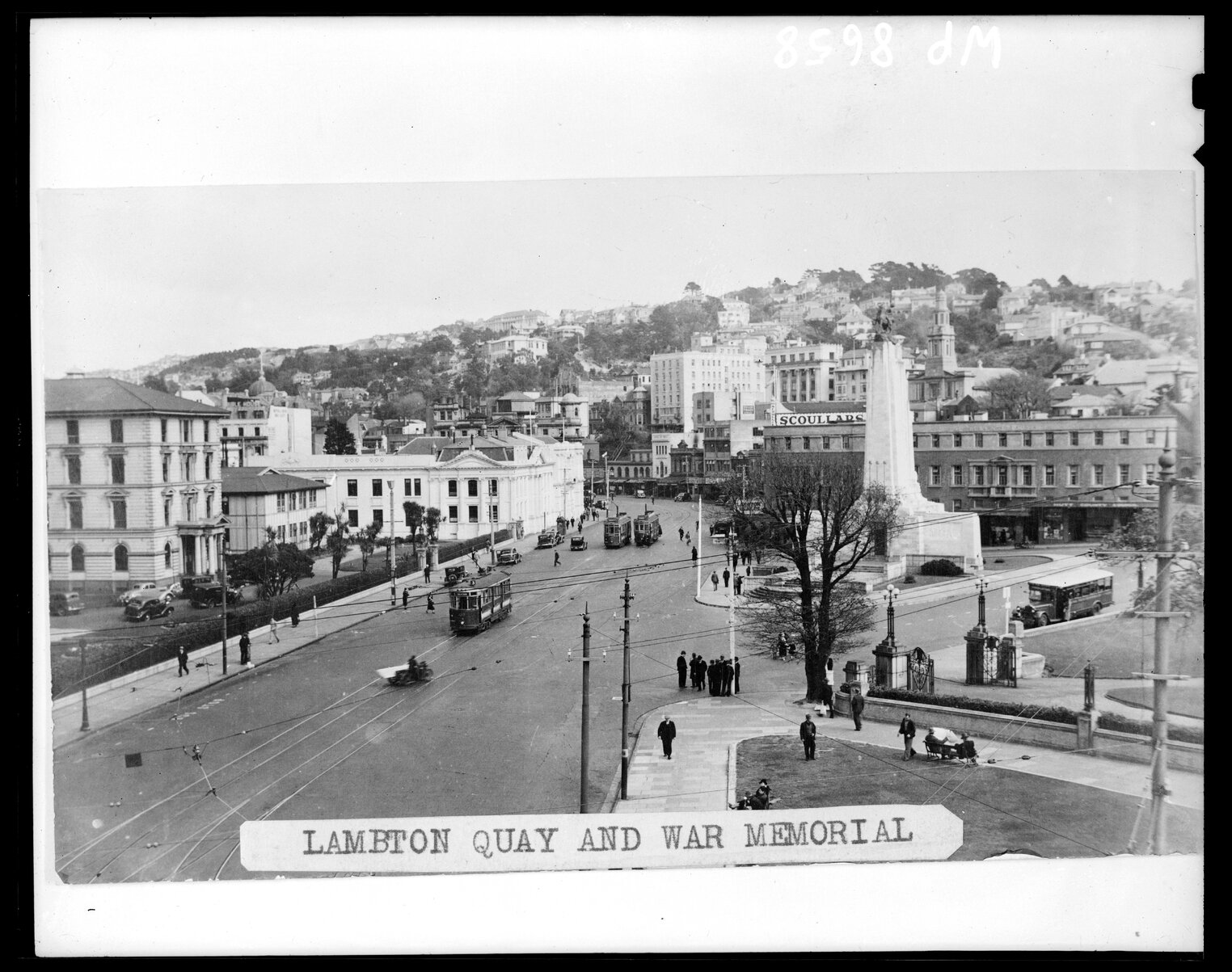 An archival photo of what Wellington city used to look like with the old government building on one side and the cenotaph on the other.