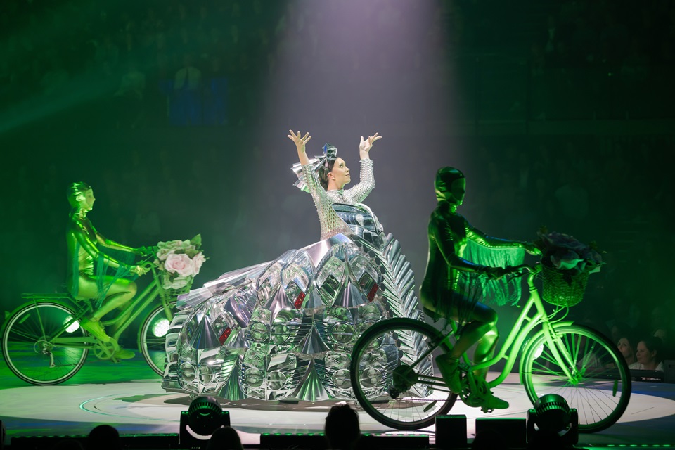 Performer on stage wearing wearable art outfit with bikes on stage.