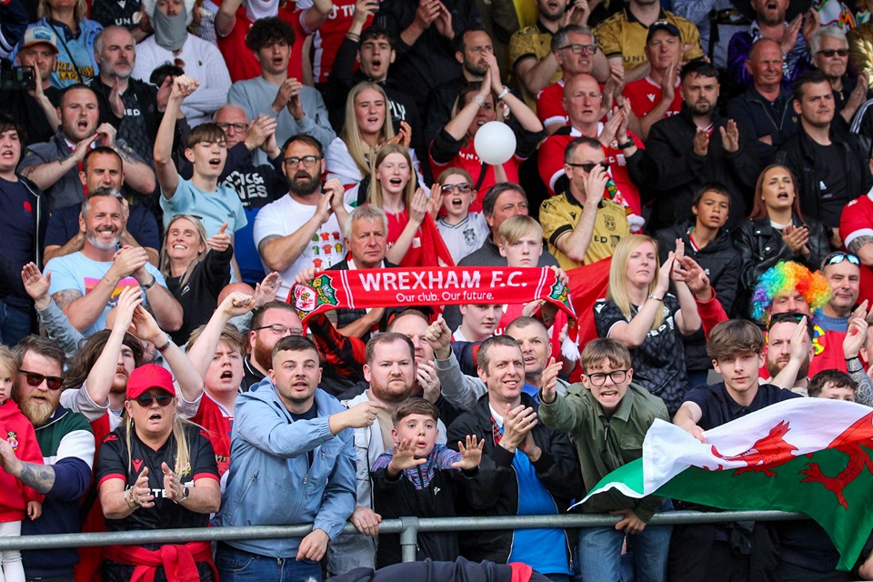 Wrexham fans watch match from stadium.