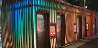 Night time exterior shot of Inglewood Toilet block with coloured lighting display.