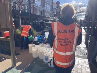 Person wearing high vis with 'volunteer' written on it.