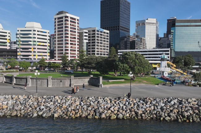 Frank Kitts rock revetment project finished with waterfront promenade and buildings in background.