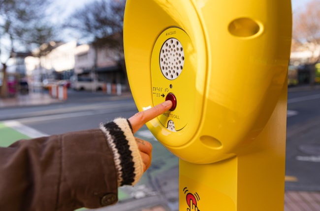 Person pushing button on Safety Point in Courtenay Place.