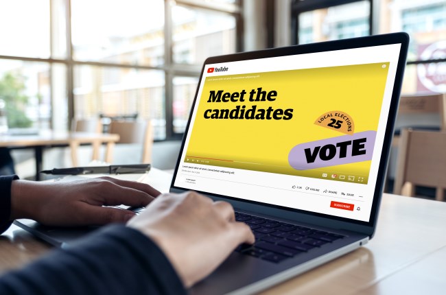 Meet the Candidates screen on laptop with hands on keyboard.