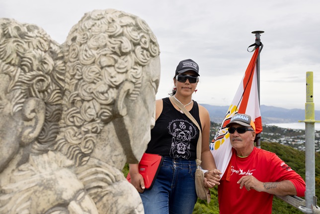Ariki and Matahi standing next to the pouwhenua 