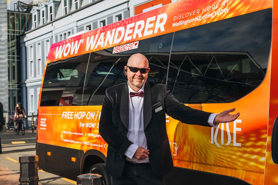 WOW Wanderer minibus with driver welcoming viewer on board.